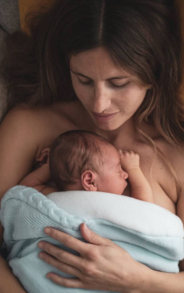 A mother having skin to skin contact time that helps encourage milk flow and natural hormones to produce milk.
